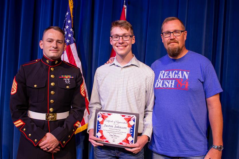 A student is honored for serving in the US Armed Forces after high school